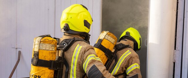 Firemen enter a building